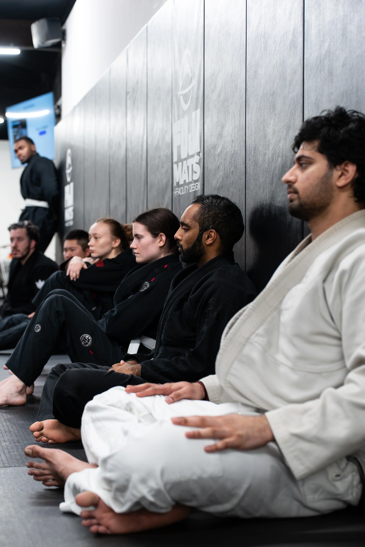 Coach demonstrating technique to experienced practitioners