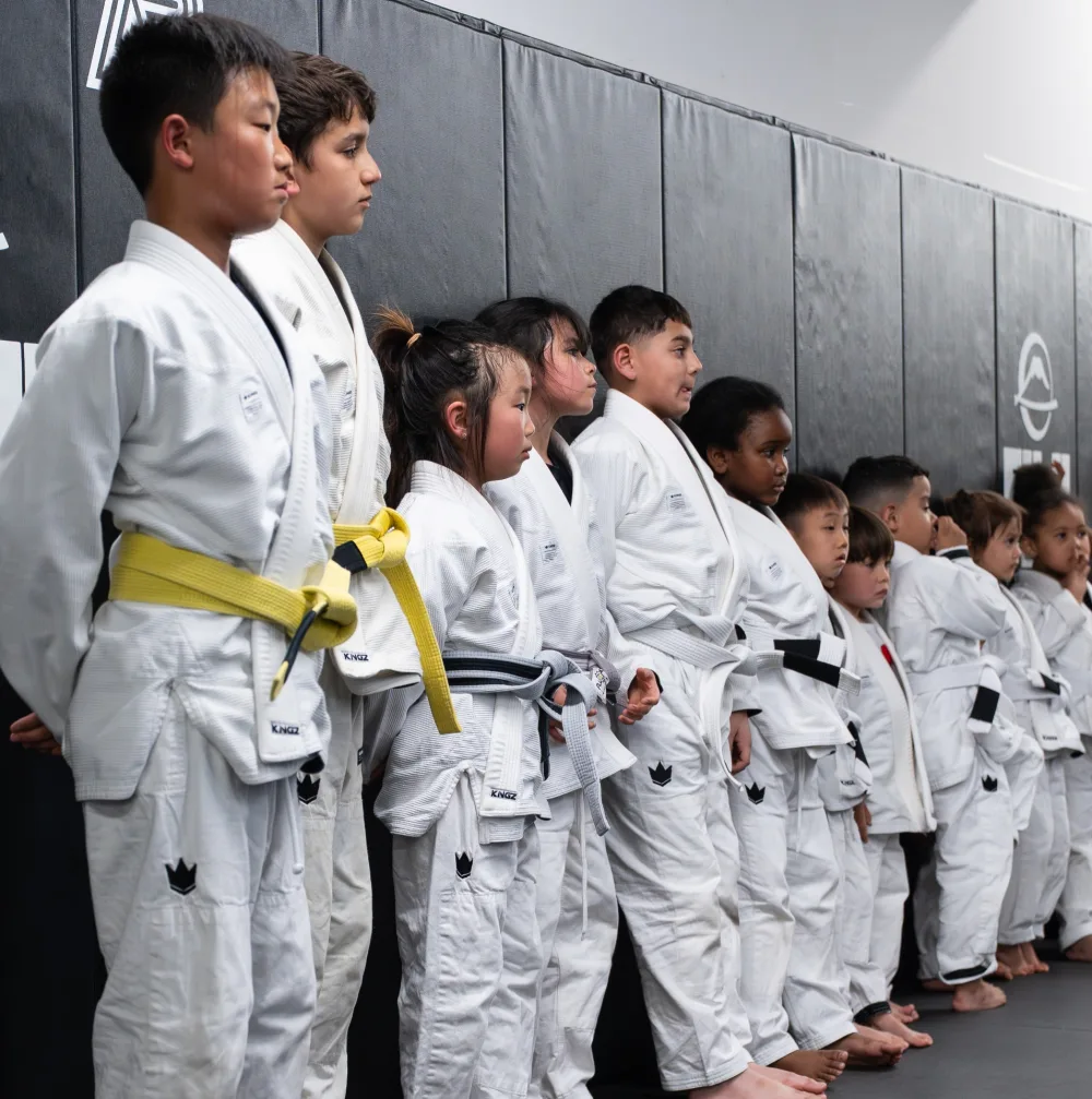 Kids lined up before jiu jitsu class