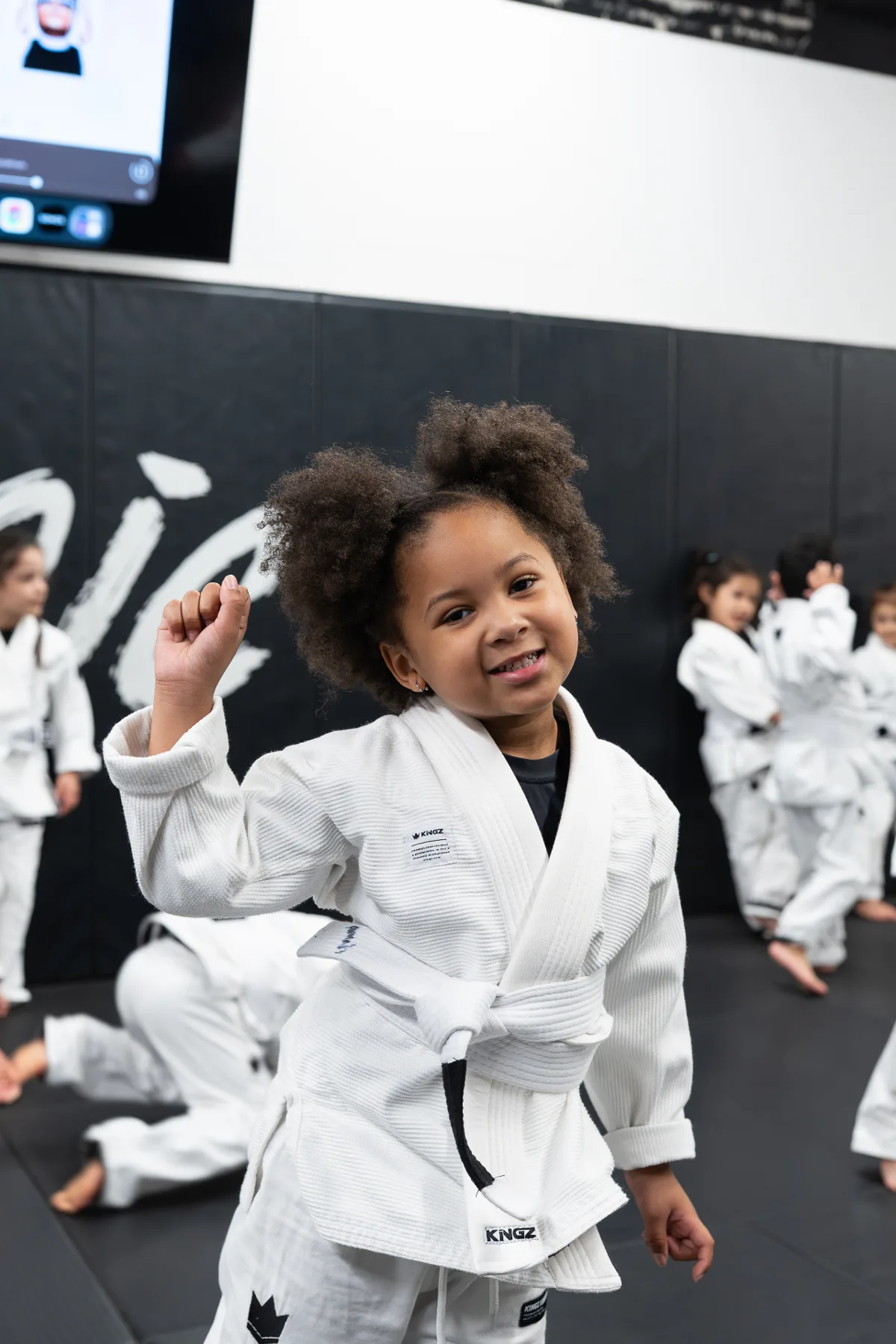 Young student smiling in a Kingz gi after class at Logic Jiu Jitsu Philadelphia