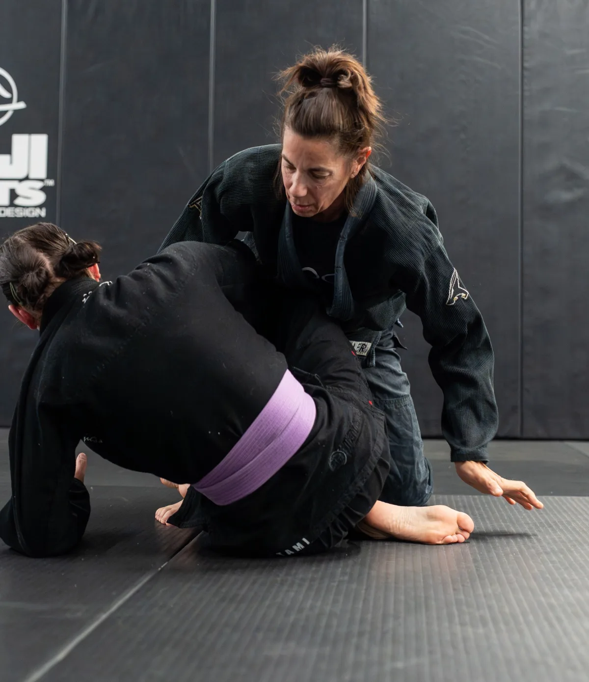 Coach Gina Mancuso, 59-year-old BJJ black belt, training with a younger purple belt at Logic Jiu Jitsu Philadelphia