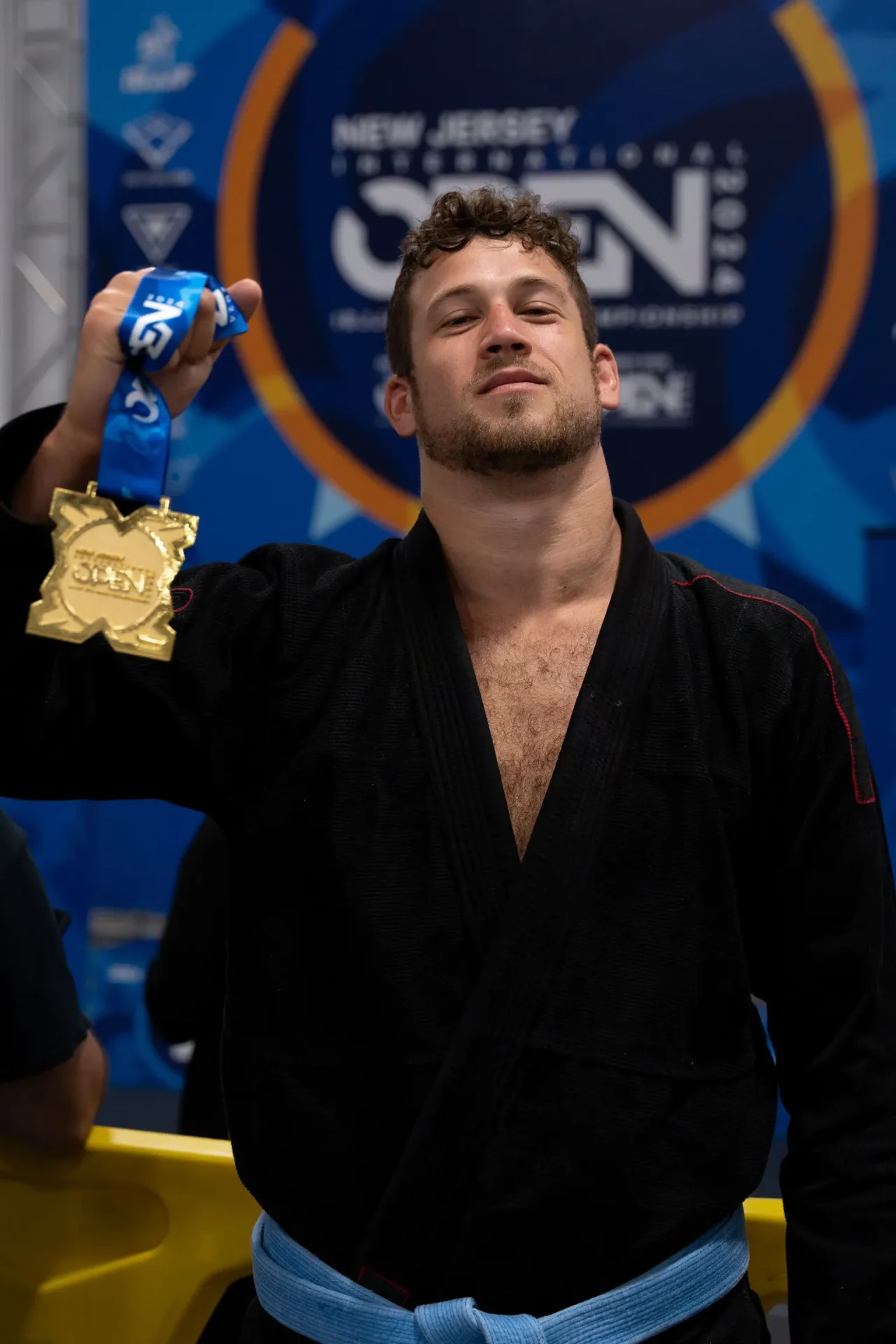 Ian holding a gold medal at the New Jersey International Open