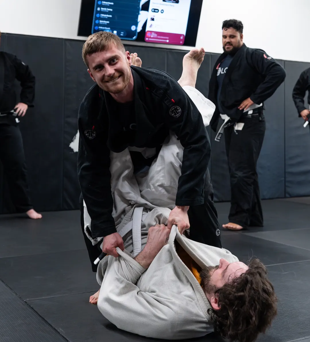 White belt smiling mid-round at Logic Jiu Jitsu